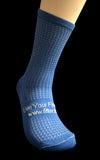 Blue sock with text on a dark background