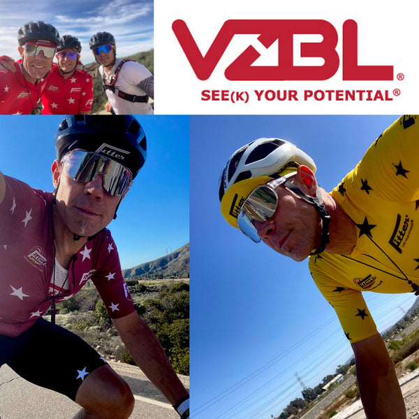 Cyclists in red and yellow jerseys with Vizbl logo and slogan.