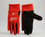Red and black gloves with a visible brand logo on a dark surface