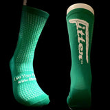 Green socks with 'Fitter' logo on a dark background